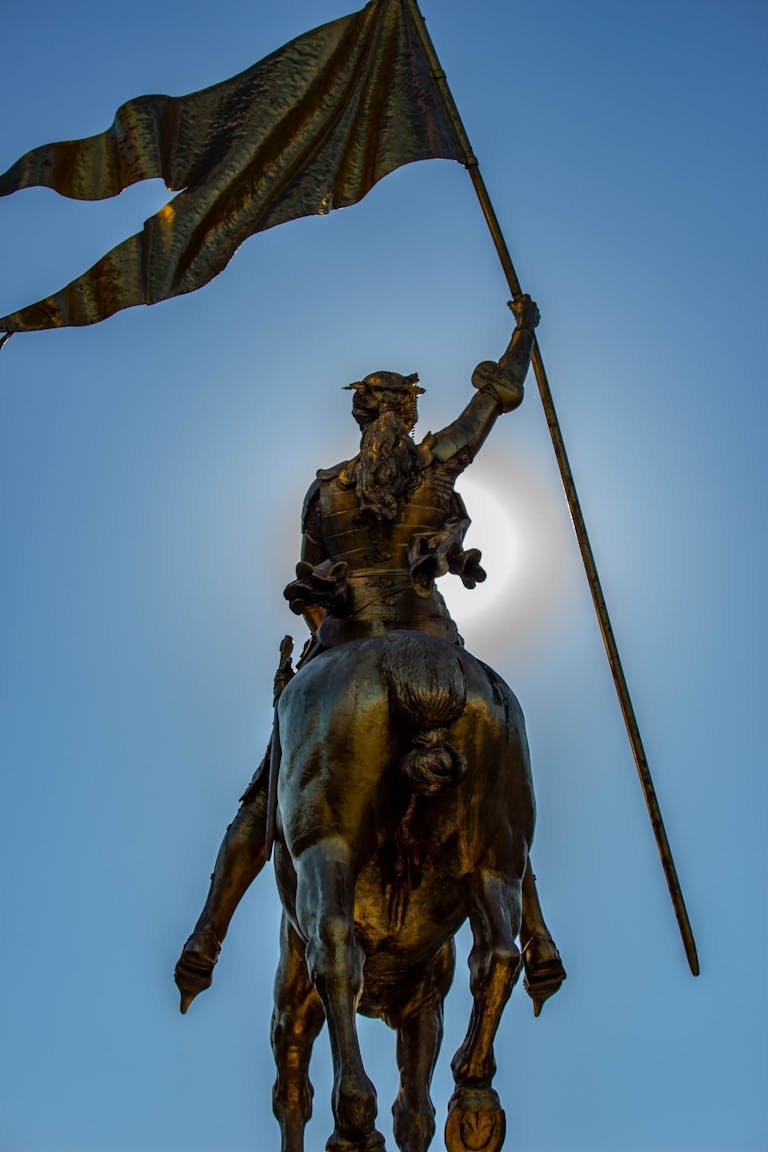 Spectacular backlit equestrian statue holding a flag, captured at sunrise in New Orleans.